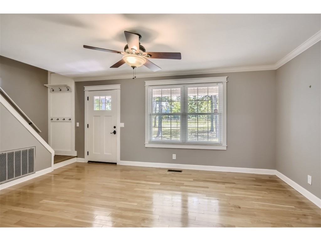 6824 Beckwith Road Mount Juliet, TN 37122 - Photo 2 of 36 a view of an empty room with wooden floor and a window