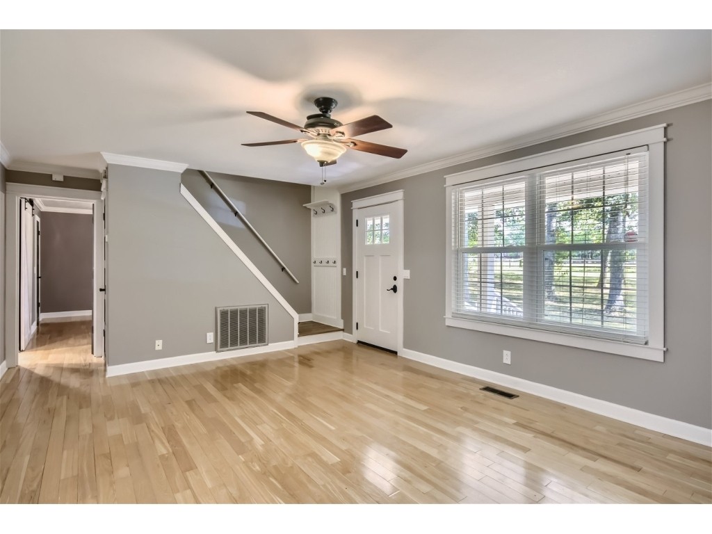 6824 Beckwith Road Mount Juliet, TN 37122 - Photo 3 of 36 a view of an empty room with chandelier fan and wooden floor