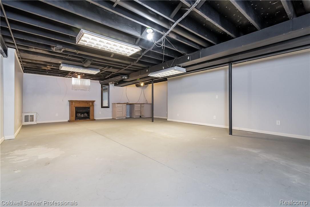 53828 Orson Road New Baltimore, MI 48047 - Photo 28 of 39 Partially finished lower level with fireplace