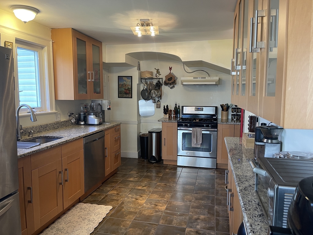 a kitchen with stainless steel appliances granite countertop a stove and a sink