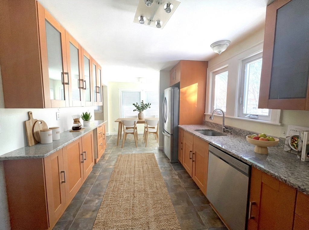 76 Cloverdale Road, Unit 76 Newton, MA 02461 - Photo 2 of 9 a large kitchen with stainless steel appliances granite countertop lots of counter space and a sink