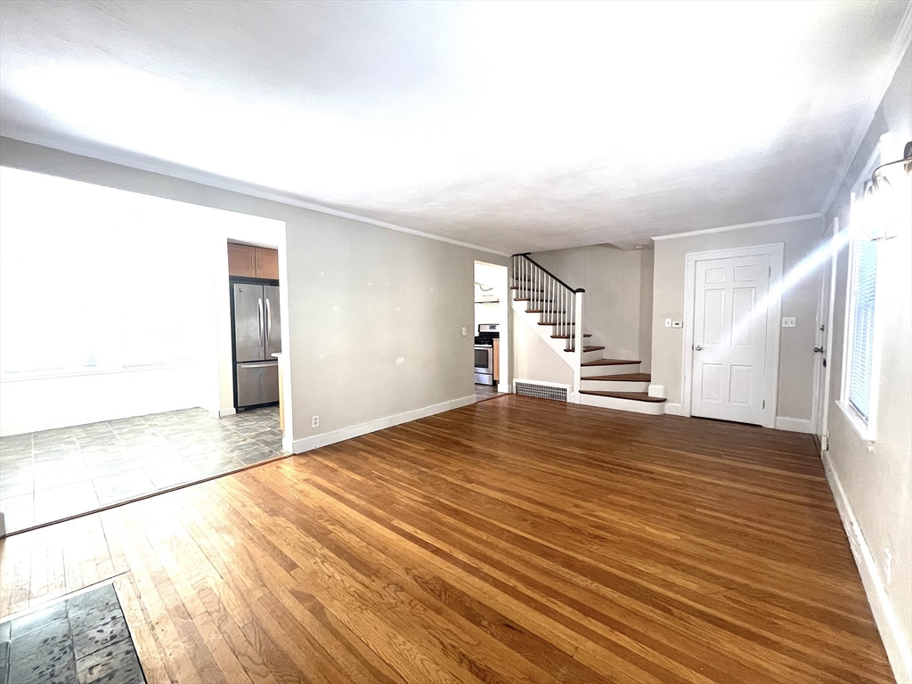76 Cloverdale Road, Unit 76 Newton, MA 02461 - Photo 3 of 10 a view of empty room with wooden floor