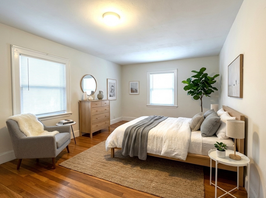 76 Cloverdale Road, Unit 76 Newton, MA 02461 - Photo 6 of 9 a bedroom with a bed and wooden floor