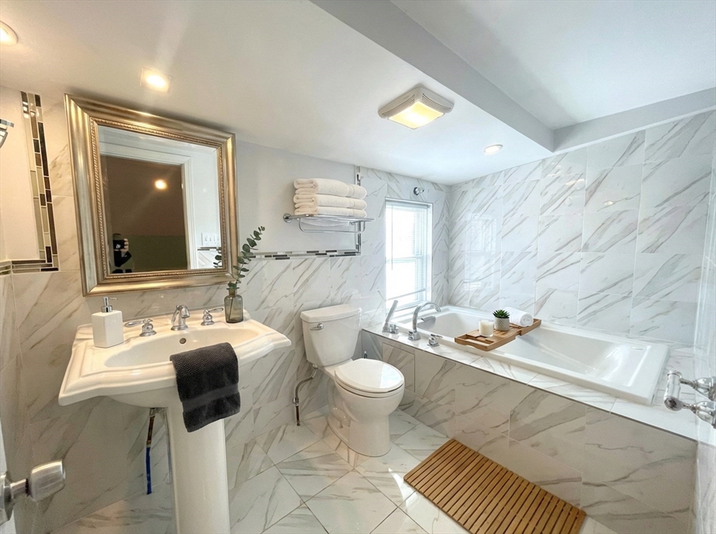 76 Cloverdale Road, Unit 76 Newton, MA 02461 - Photo 7 of 9 a bathroom with a sink toilet and mirror