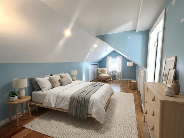 a bedroom with a bed and a large mirror with window