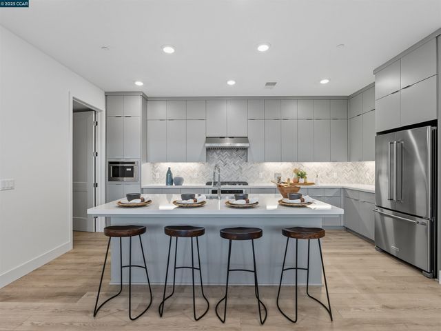 a kitchen with refrigerator and cabinets