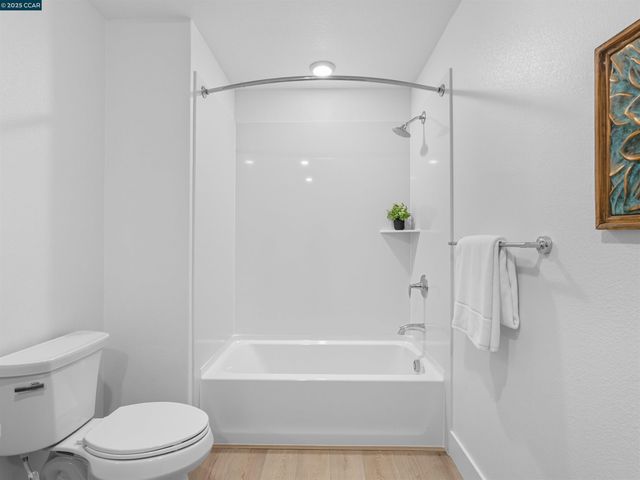 a bathroom with a bathtub toilet and shower