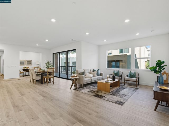 a living room with furniture and a table with wooden floor