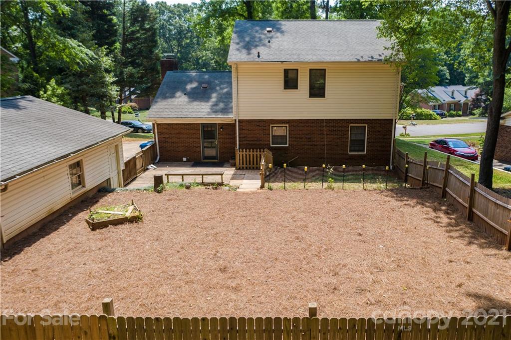 412 Neill Ridge Road Matthews, NC 28105 - Photo 23 of 25 a front view of house with yard outdoor seating and yard in back