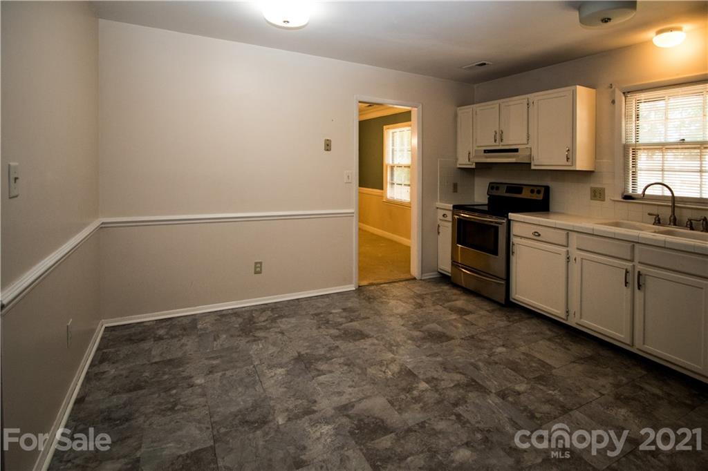 412 Neill Ridge Road Matthews, NC 28105 - Photo 6 of 25 a kitchen with a sink stove and cabinets