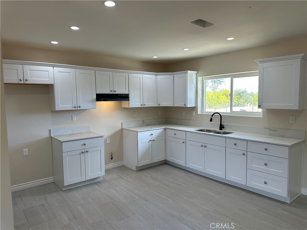 22661 Fisher Street Perris, CA 92570 - Photo 3 of 10 a kitchen with sink cabinets and window