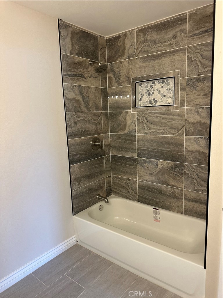 22661 Fisher Street Perris, CA 92570 - Photo 8 of 10 a bathroom with a bathtub and a shower