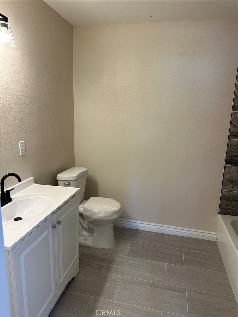 22661 Fisher Street Perris, CA 92570 - Photo 9 of 10 a bathroom with a white toilet and sink