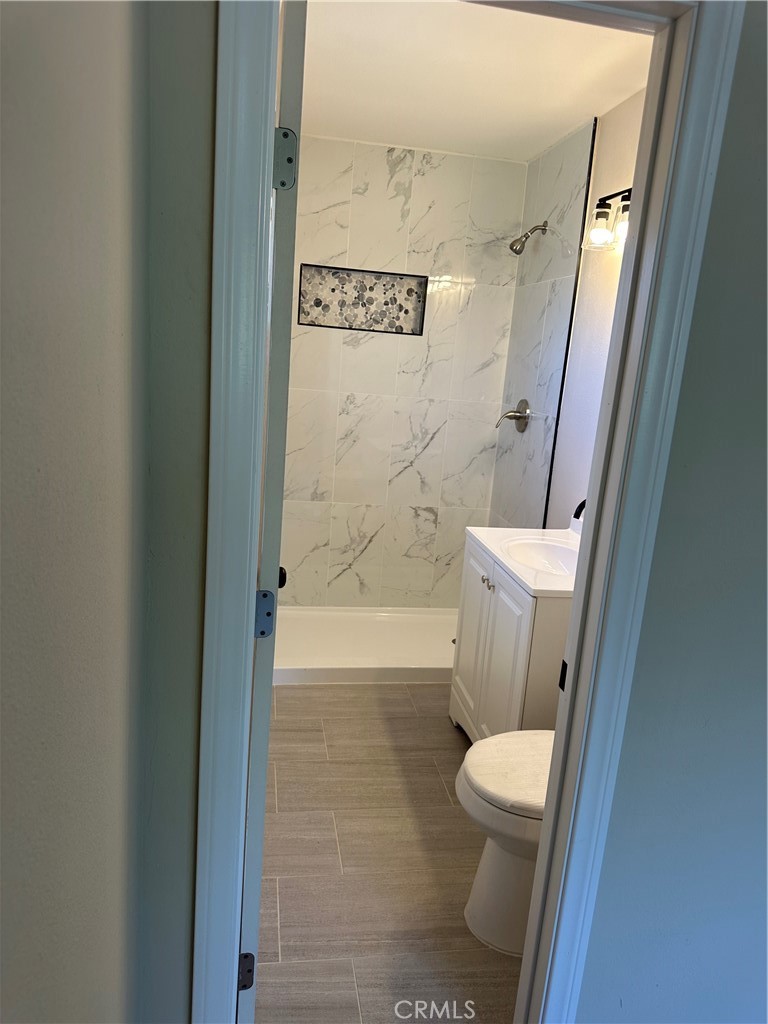 22661 Fisher Street Perris, CA 92570 - Photo 10 of 10 a bathroom with a toilet and a shower