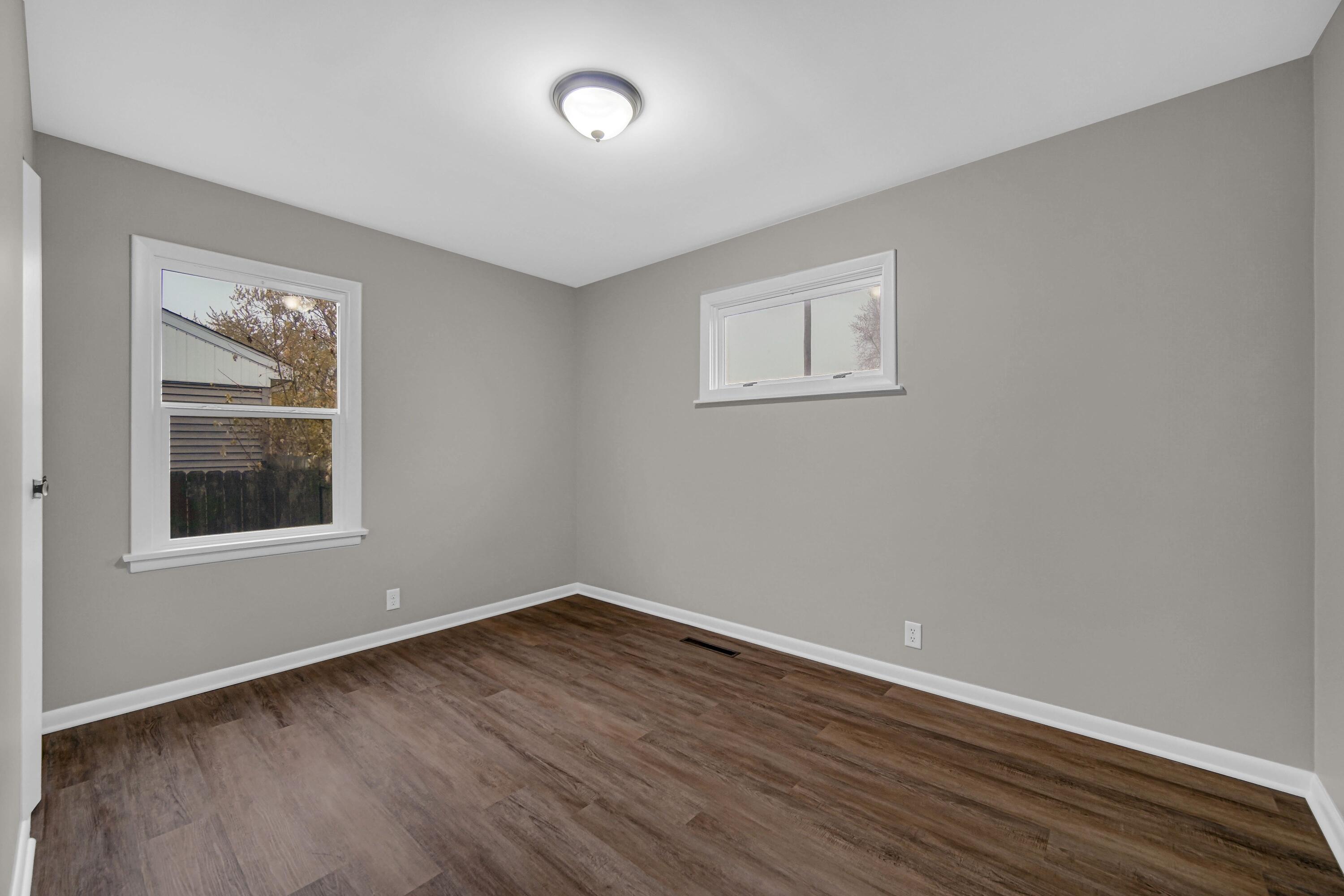 3302 Eder Street Highland, IN 46322 - Photo 11 of 19 a view of an empty room with wooden floor and a window