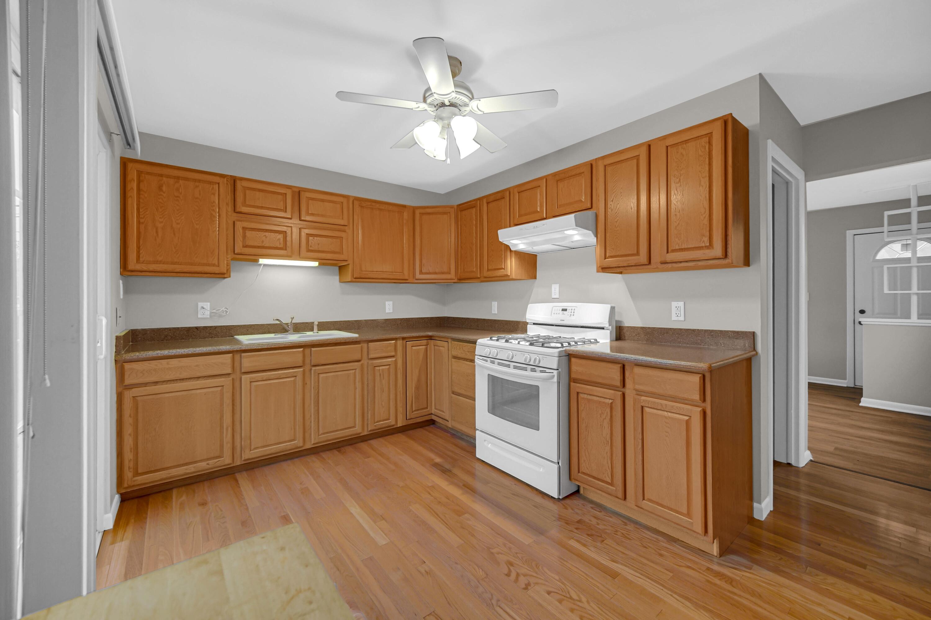 3302 Eder Street Highland, IN 46322 - Photo 5 of 19 a kitchen with granite countertop white cabinets and white appliances