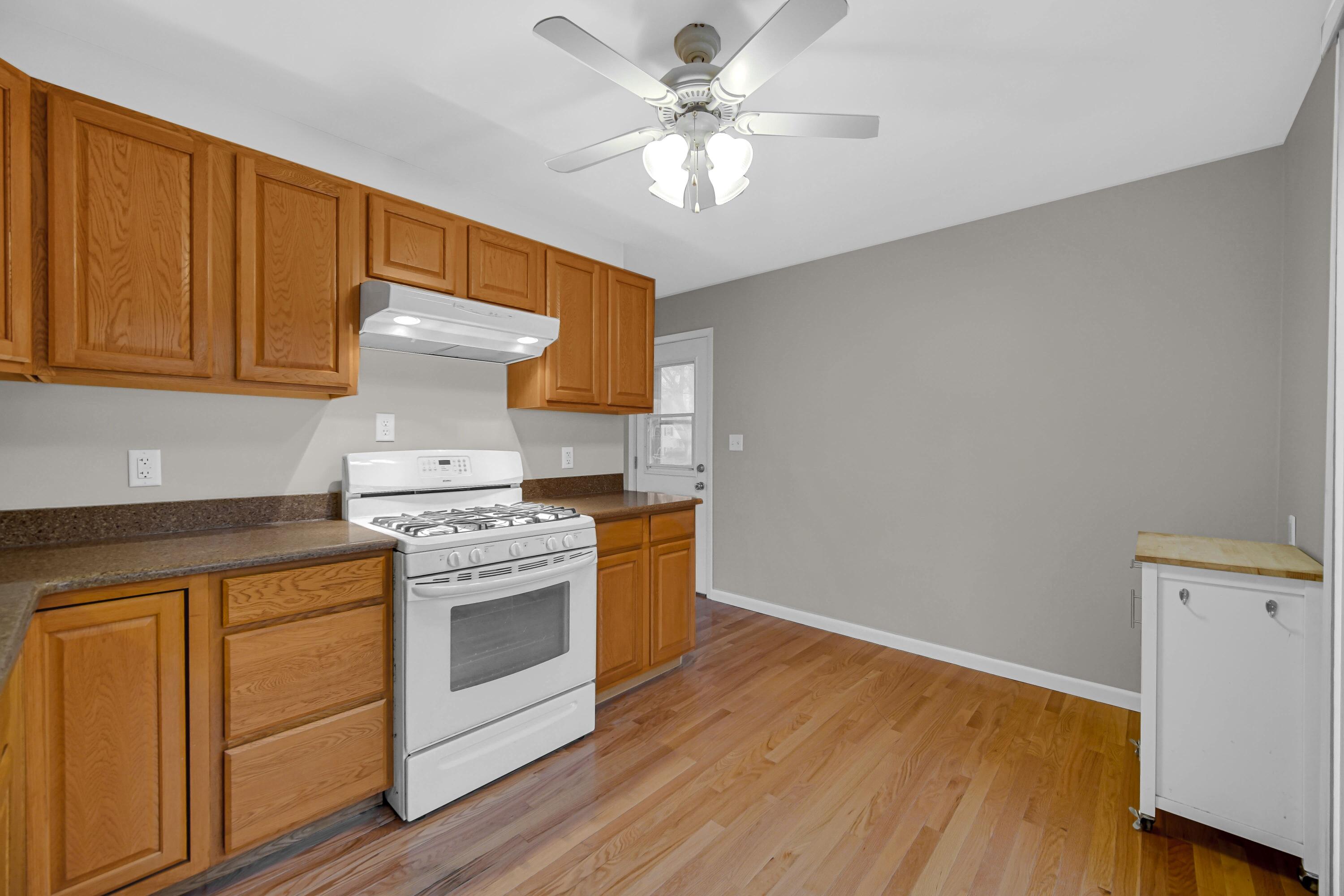 3302 Eder Street Highland, IN 46322 - Photo 7 of 19 a kitchen with a stove oven and white cabinets