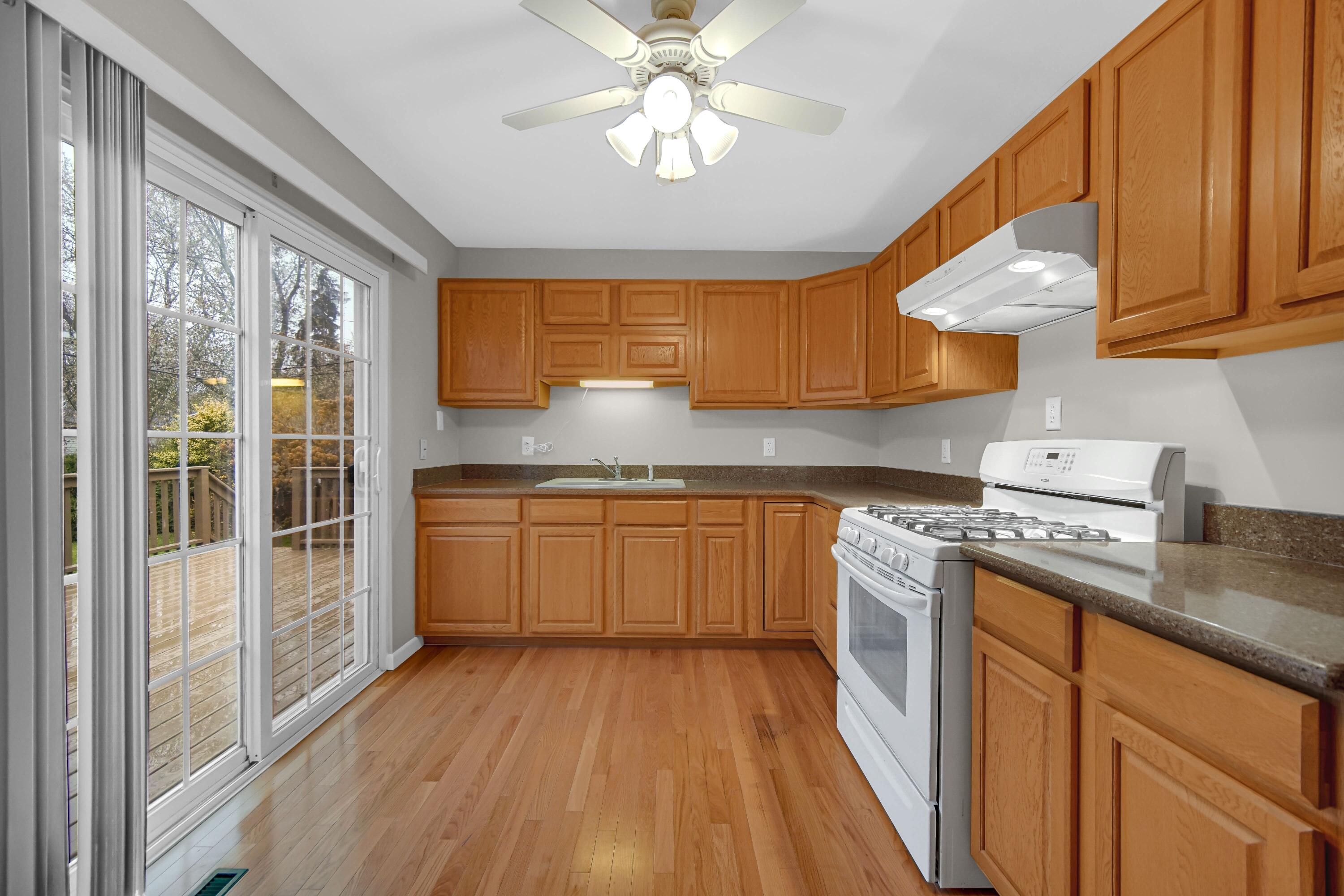 3302 Eder Street Highland, IN 46322 - Photo 8 of 19 a kitchen with a stove a sink and a refrigerator