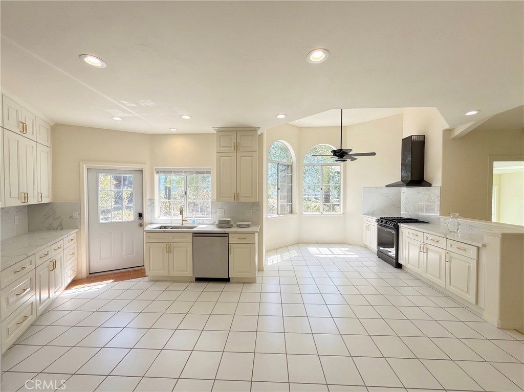 39850 Kapalua Way Temecula, CA 92592 - Photo 12 of 35 a large white kitchen with cabinets