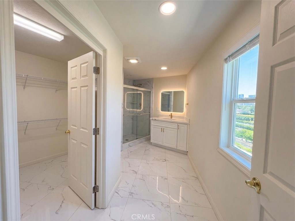 39850 Kapalua Way Temecula, CA 92592 - Photo 16 of 35 a view of a hallway with bathroom and shower