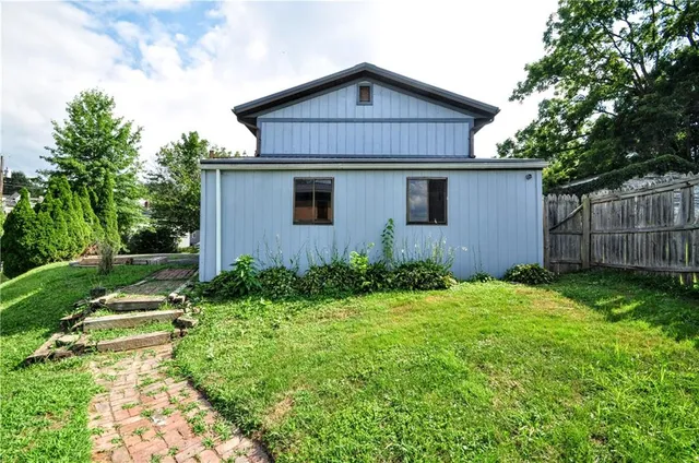 a kitchen with stainless steel appliances granite countertop a stove a sink dishwasher a microwave oven and a dining table with wooden floor