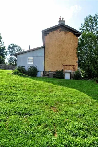 a view of a house with a yard and sitting area