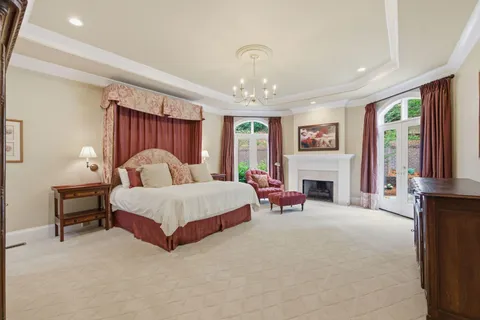 a spacious bathroom with a granite countertop sink a toilet a shower and a mirror