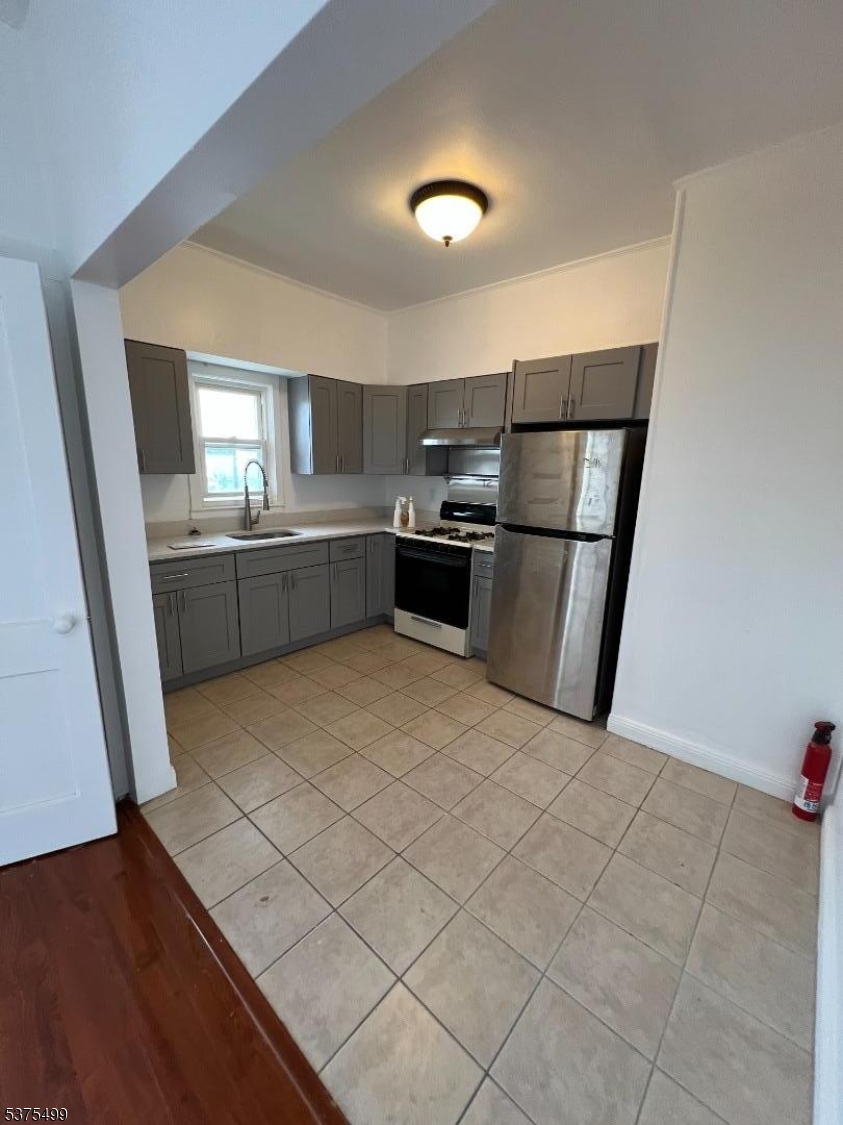 48 1st Avenue Raritan, NJ 08869 - Photo 4 of 10 a kitchen with a sink a stove top oven and cabinetry