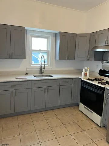 a kitchen with a sink and a stove top oven