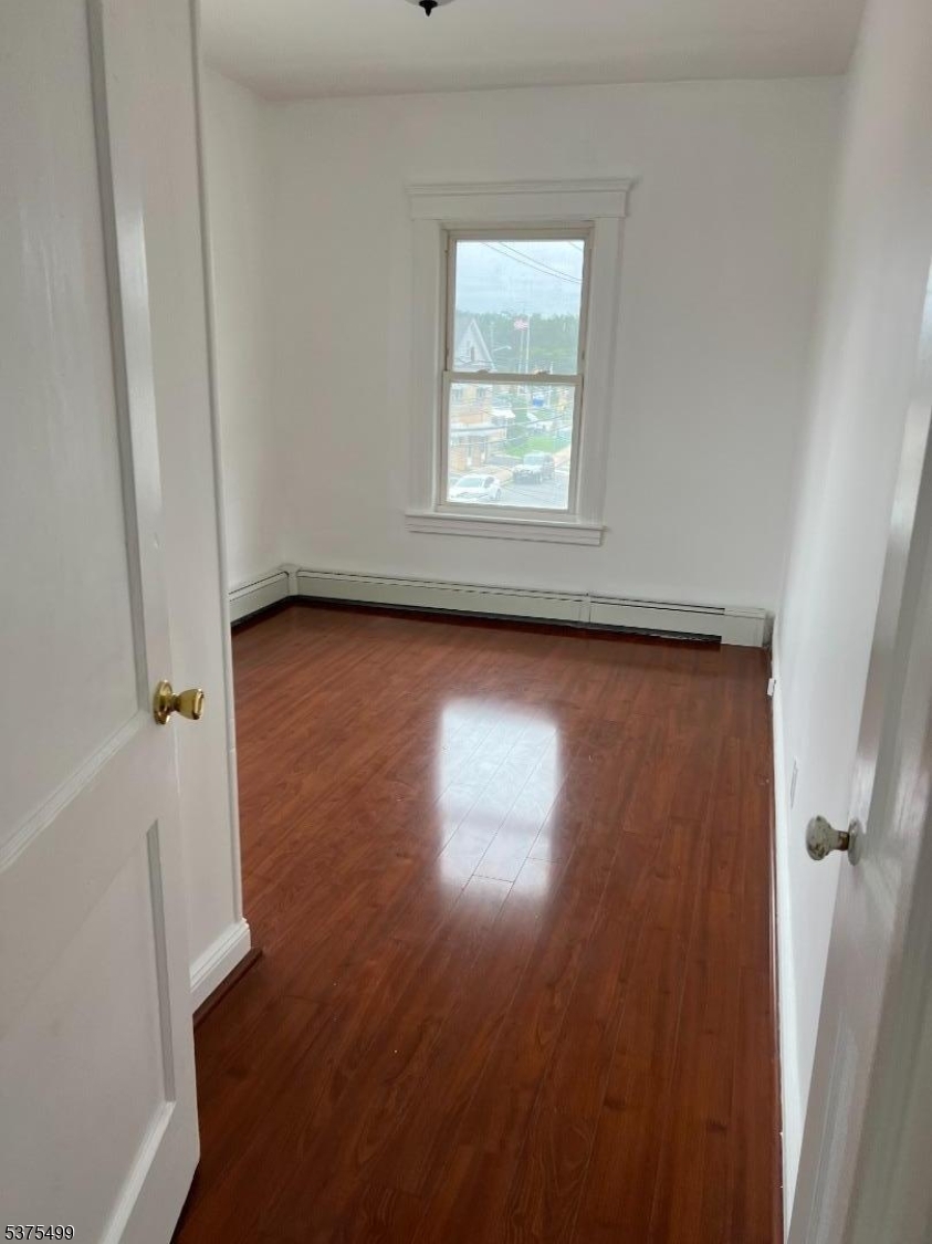 48 1st Avenue Raritan, NJ 08869 - Photo 8 of 10 an empty room with wooden floor and windows