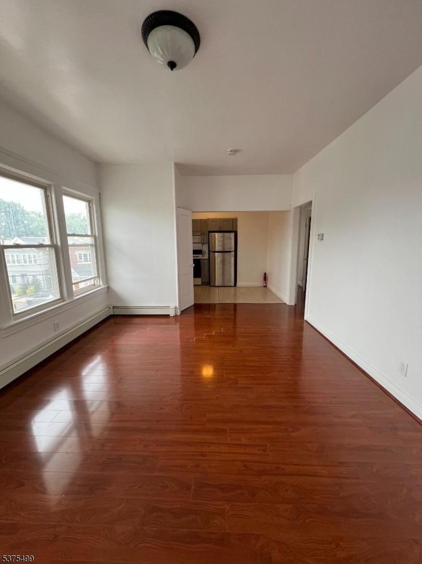48 1st Avenue Raritan, NJ 08869 - Photo 10 of 10 an empty room with wooden floor and windows