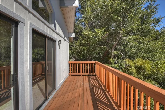 a roof deck with wooden floor and fence