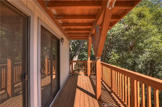 a view of a house with large trees and a barn