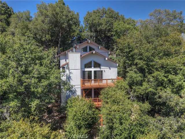 an aerial view of house with yard and outdoor seating