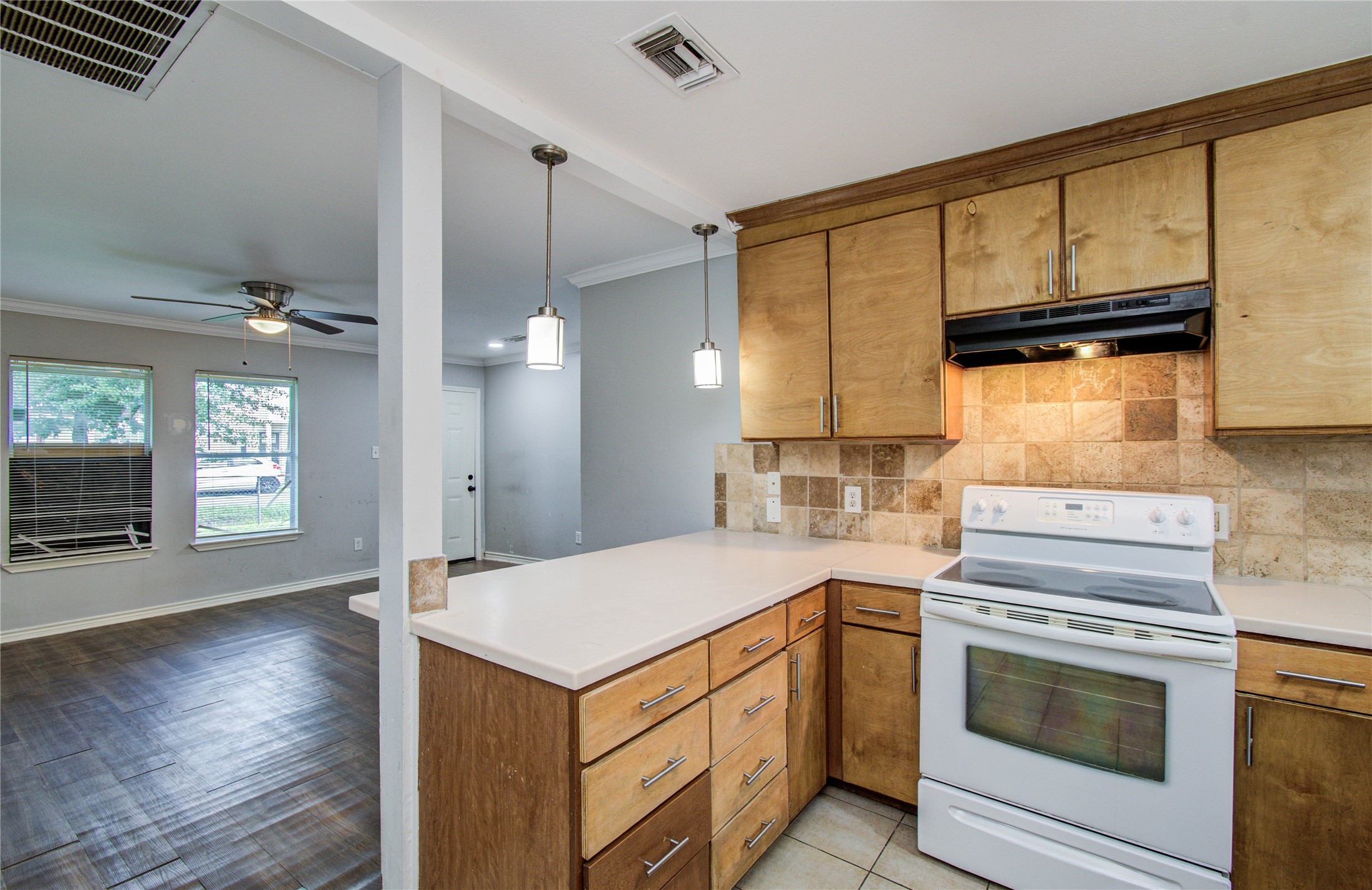 6830 New York Street Houston, TX 77021 - Photo 14 of 28 a kitchen with a stove cabinets and wooden floor