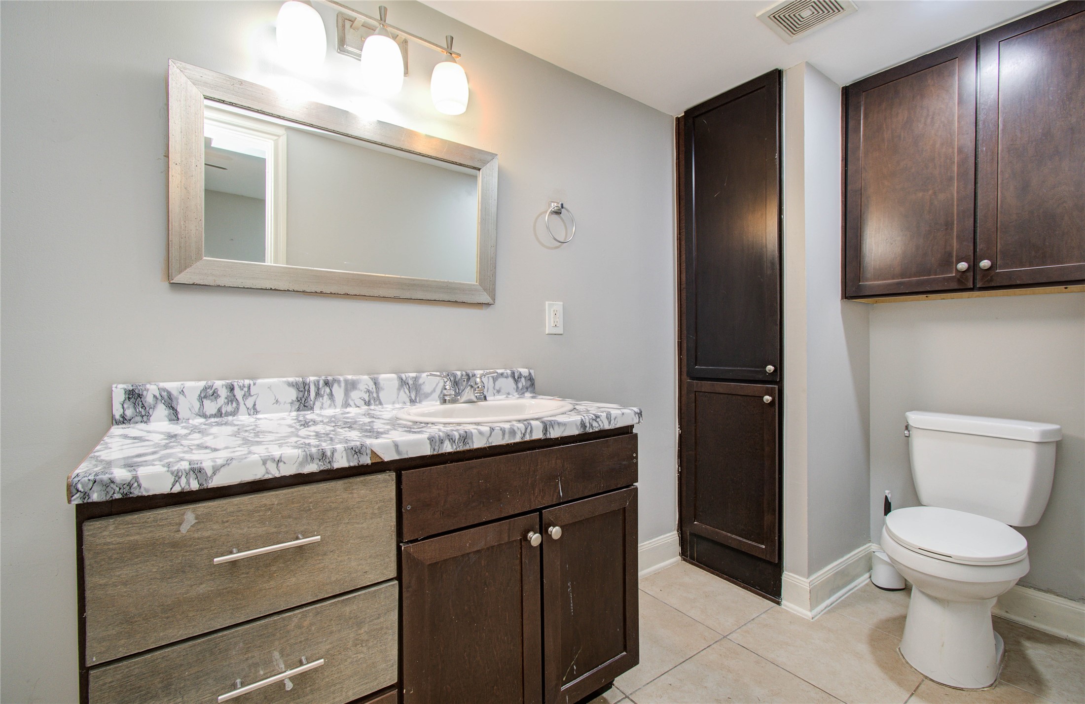 6830 New York Street Houston, TX 77021 - Photo 17 of 28 a bathroom with a granite countertop sink toilet and mirror