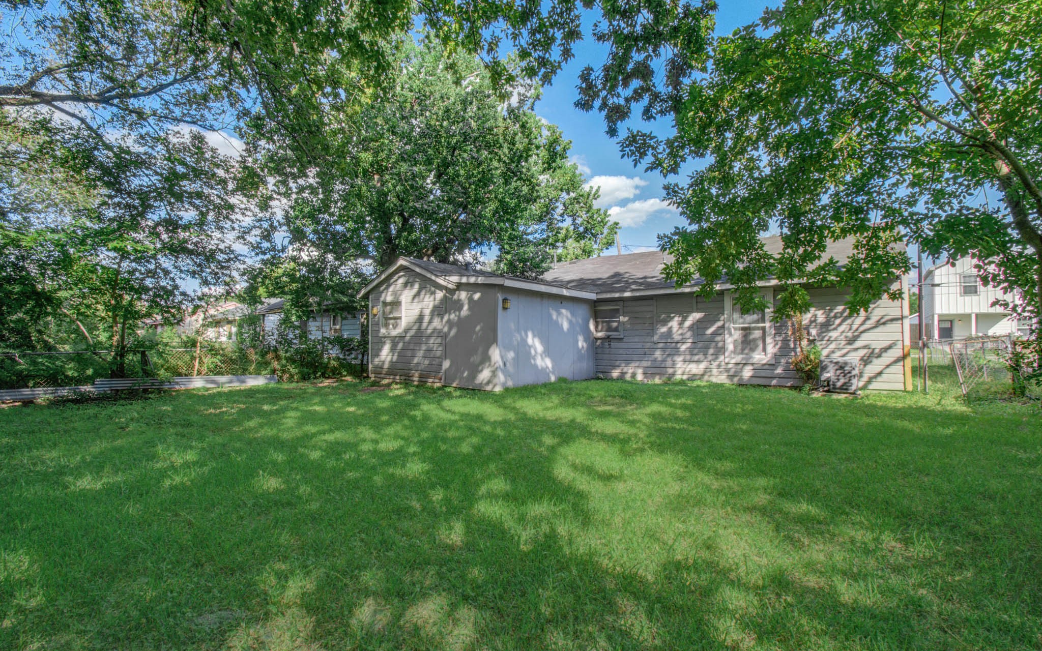 6830 New York Street Houston, TX 77021 - Photo 28 of 28 a view of a backyard with large trees and plants