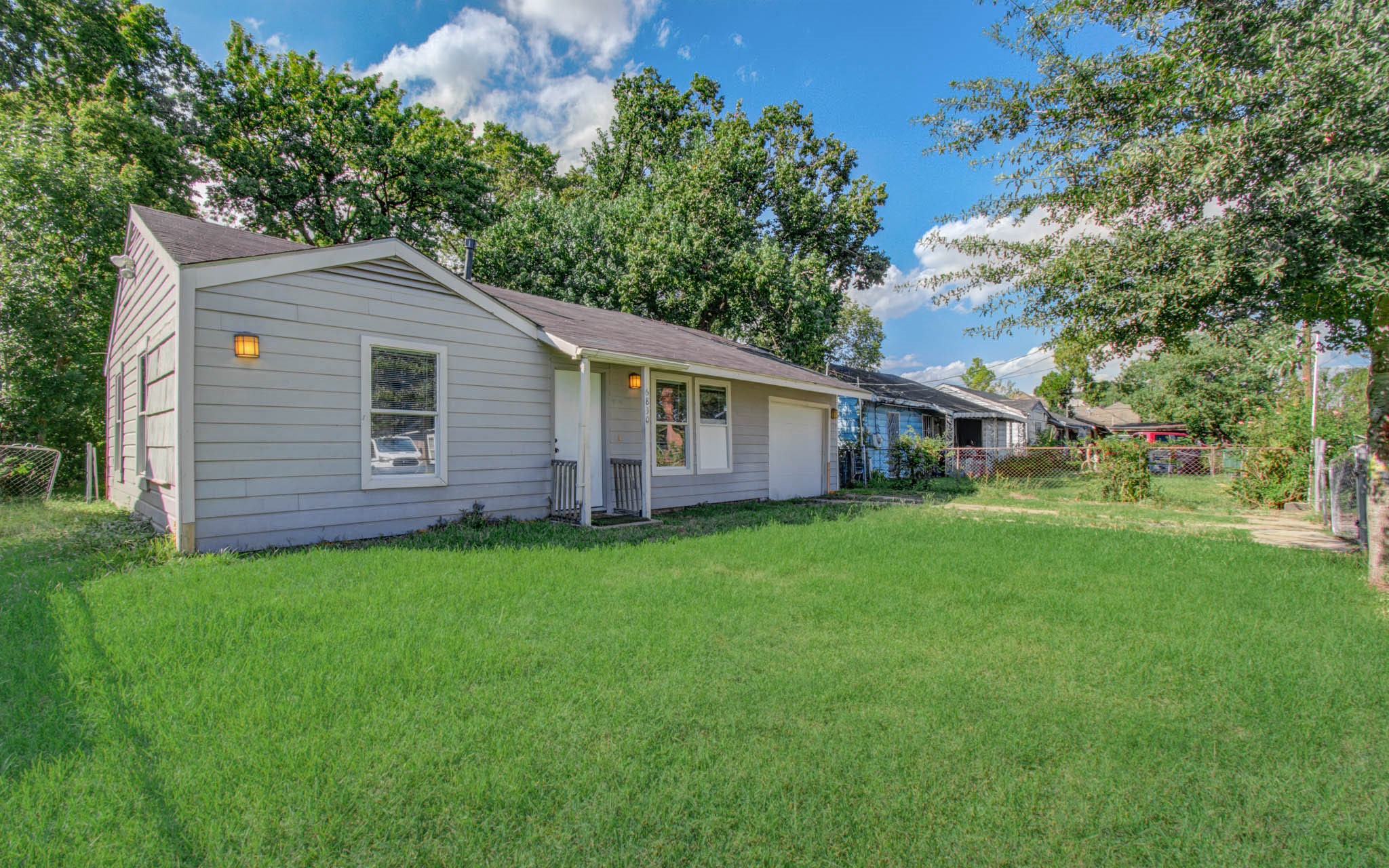 6830 New York Street Houston, TX 77021 - Photo 3 of 28 a aerial view of a house next to a yard with big trees