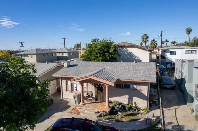 a aerial view of a house with swimming pool and furniture