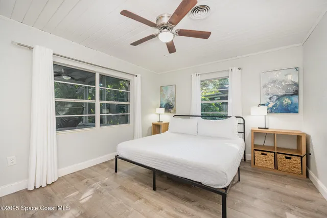 a bedroom with a bed a table and a window