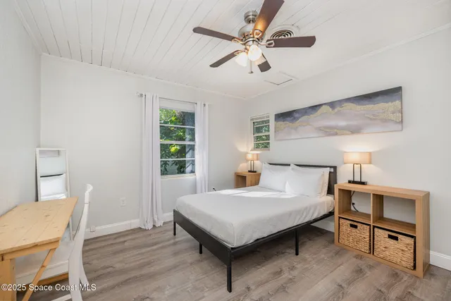 a living room with a table chairs and a window