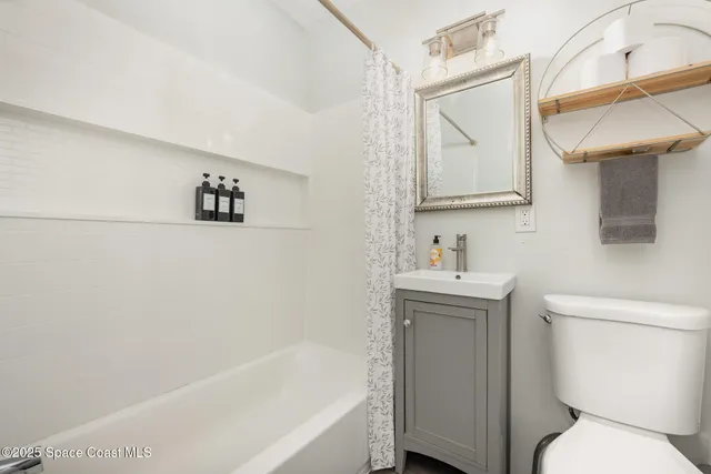 a bathroom with a sink toilet and mirror