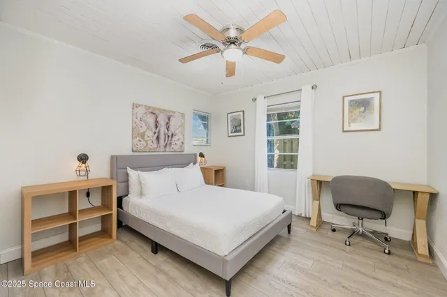 a bedroom with a bed and a desk