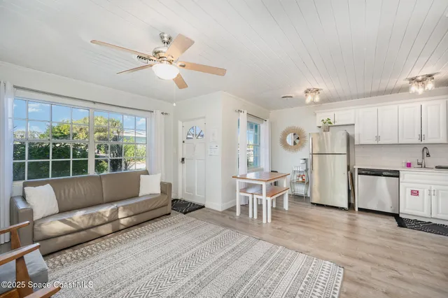 a living room with furniture and kitchen view