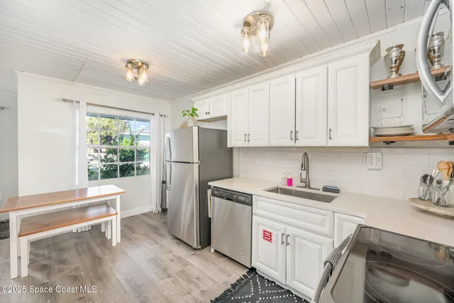 a kitchen with a sink cabinets and window