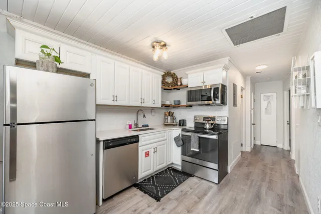 a white refrigerator freezer and a stove top oven