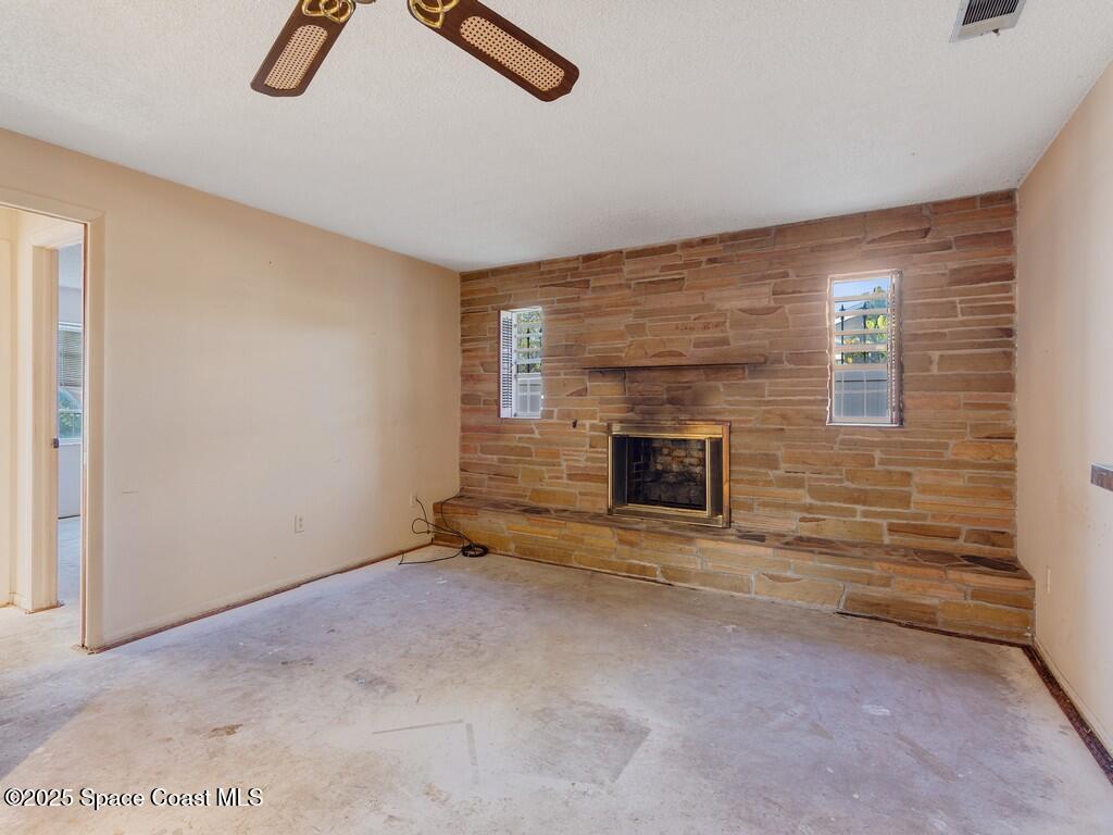 3170 Kent Drive Melbourne, FL 32935 - Photo 13 of 26 a view of empty room with fireplace and window