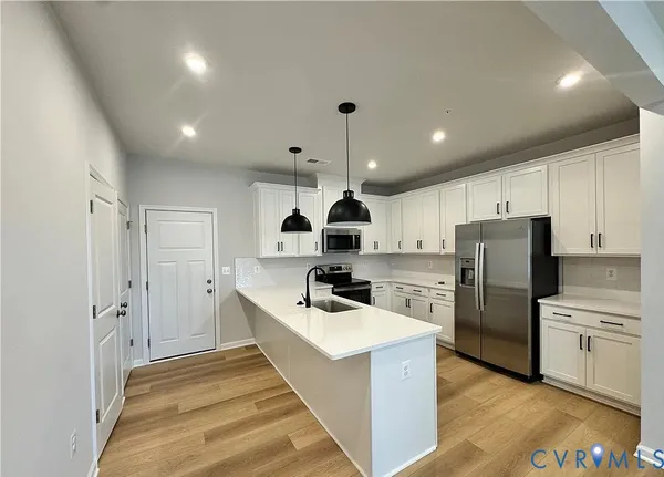 a kitchen with refrigerator a sink and cabinets