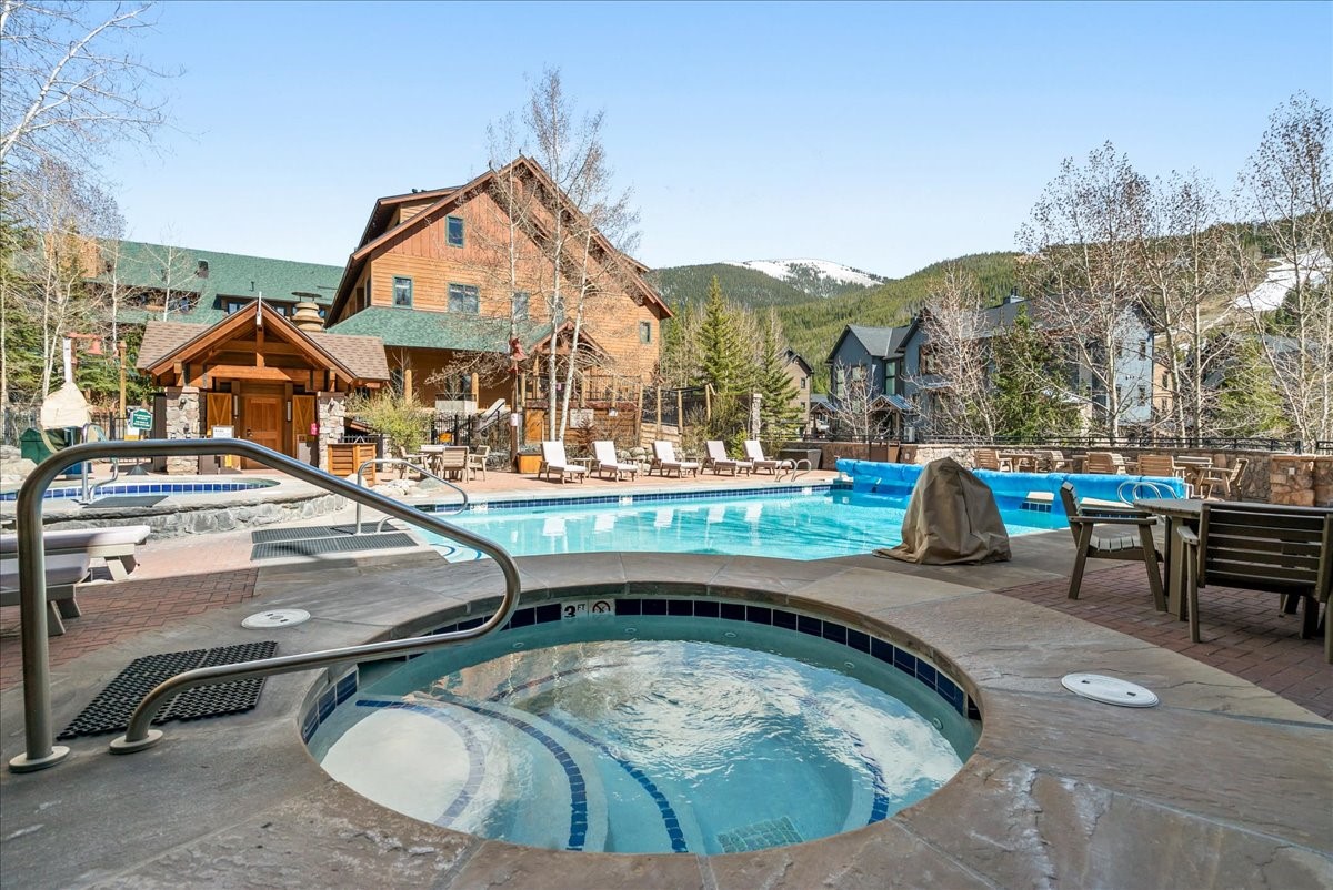 91 River Run Road, Unit 8111 Keystone, CO 80435 - Photo 30 of 43 a view of a swimming pool with a bench and lawn chairs