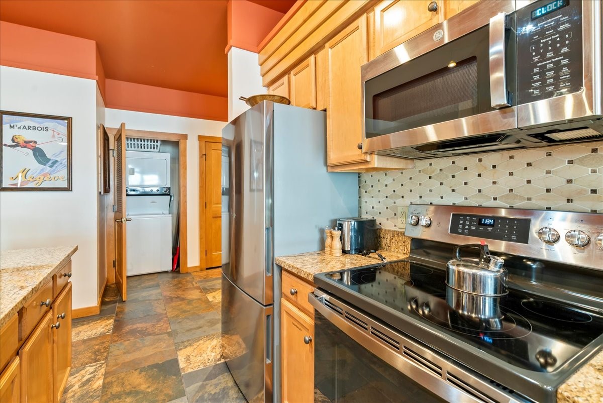91 River Run Road, Unit 8111 Keystone, CO 80435 - Photo 8 of 43 a kitchen with granite countertop a stove and a microwave